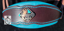 Load image into Gallery viewer, Mounted archery 🏹 padded sidepull Available! 🤎🩵🐎

Dark brown with turquoise padding and thread. Aged copper hardware with custom arrow buckles and conchos. 

Average horse size 
$395 USD

Only one available
